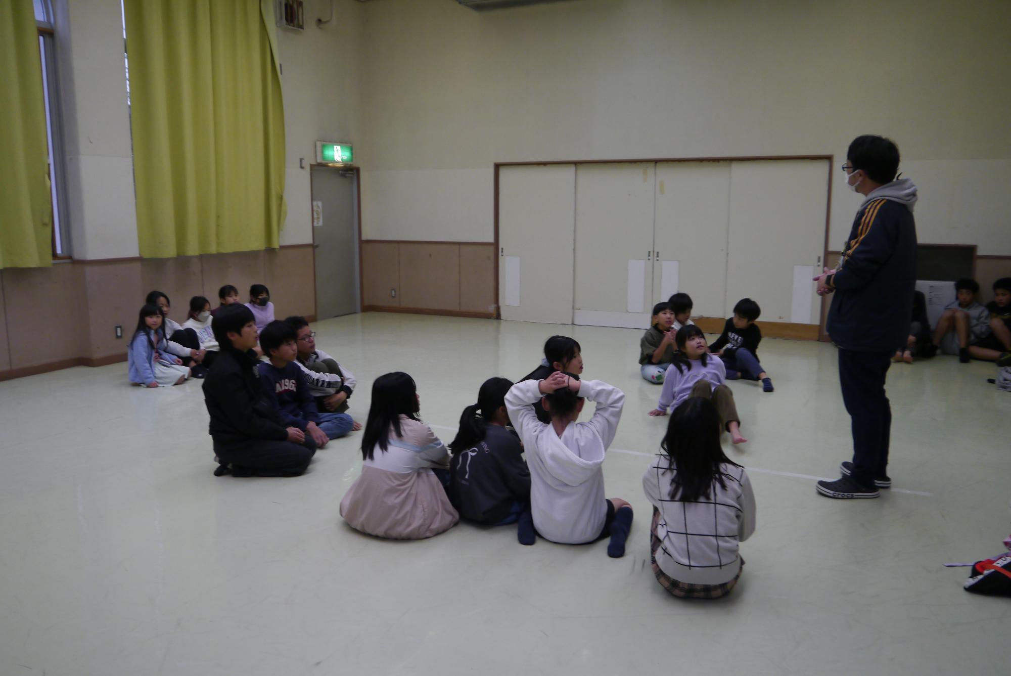 ドッジボールのルール確認をする館長と子どもたち