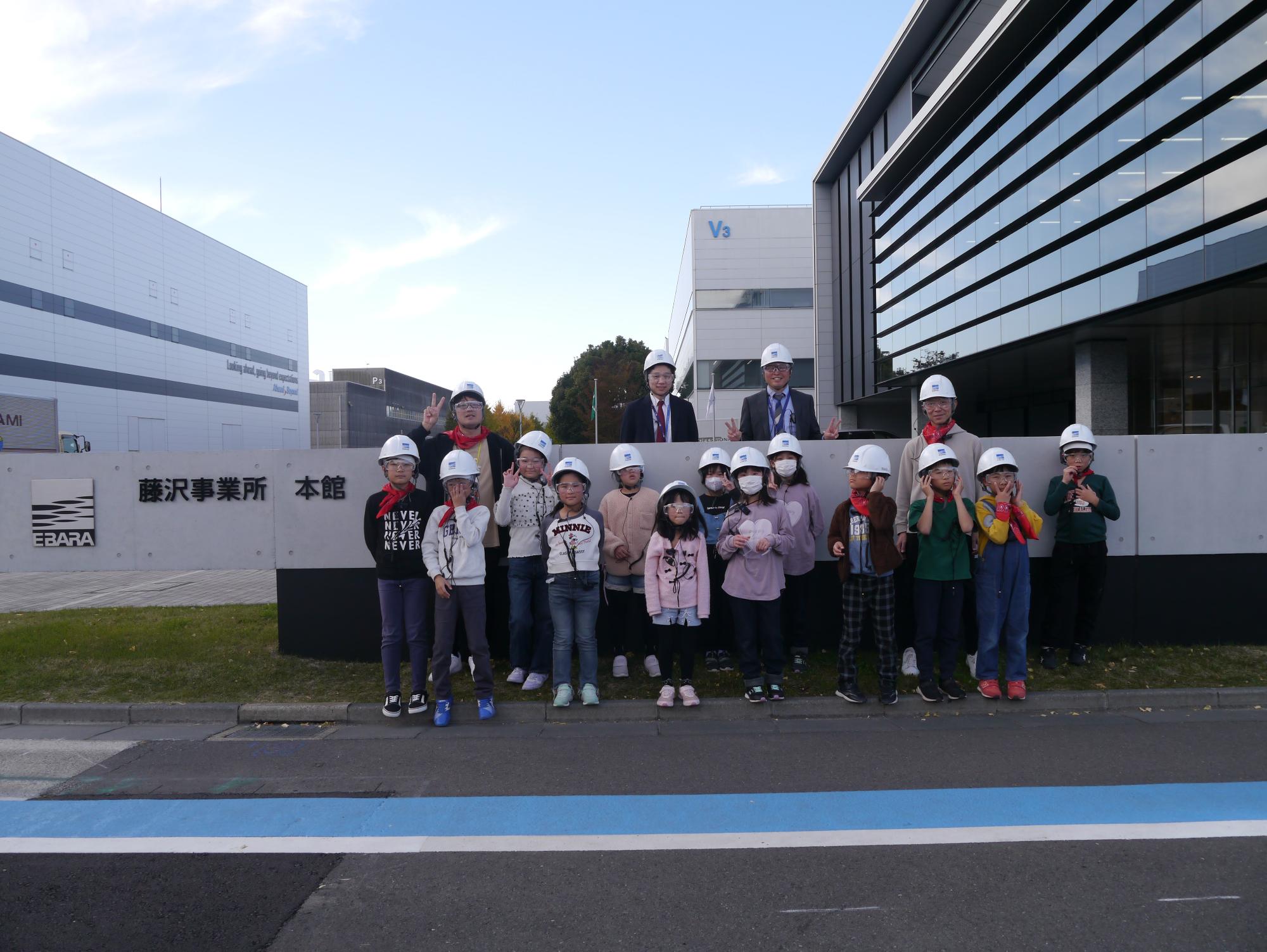 工場の前でみんなで集合写真を撮りました