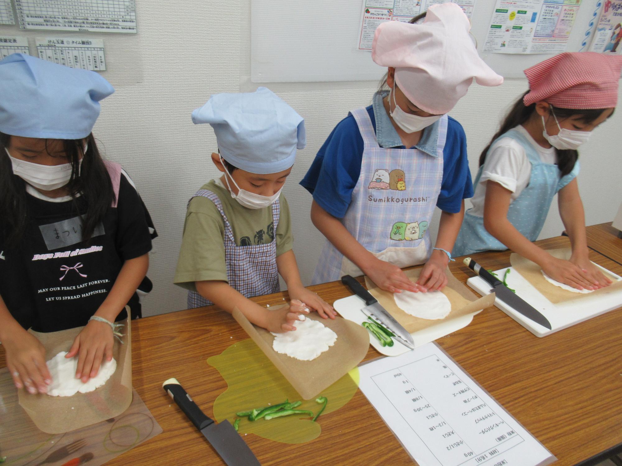 米粉ピザの材料をこねている子ども達の写真