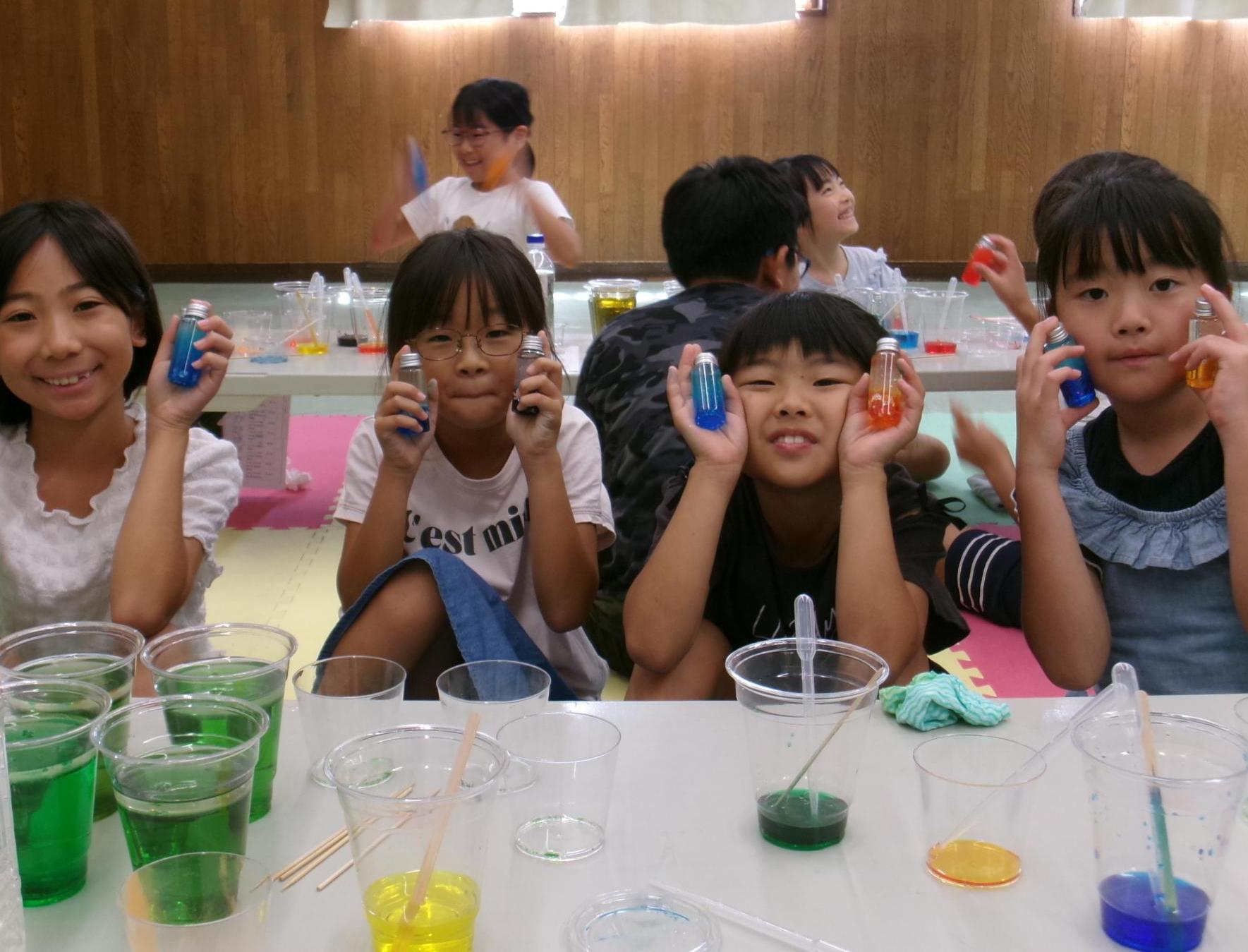 科学実験教室で作ったセンサリーボトルを見せてくれた小学生児童の写真
