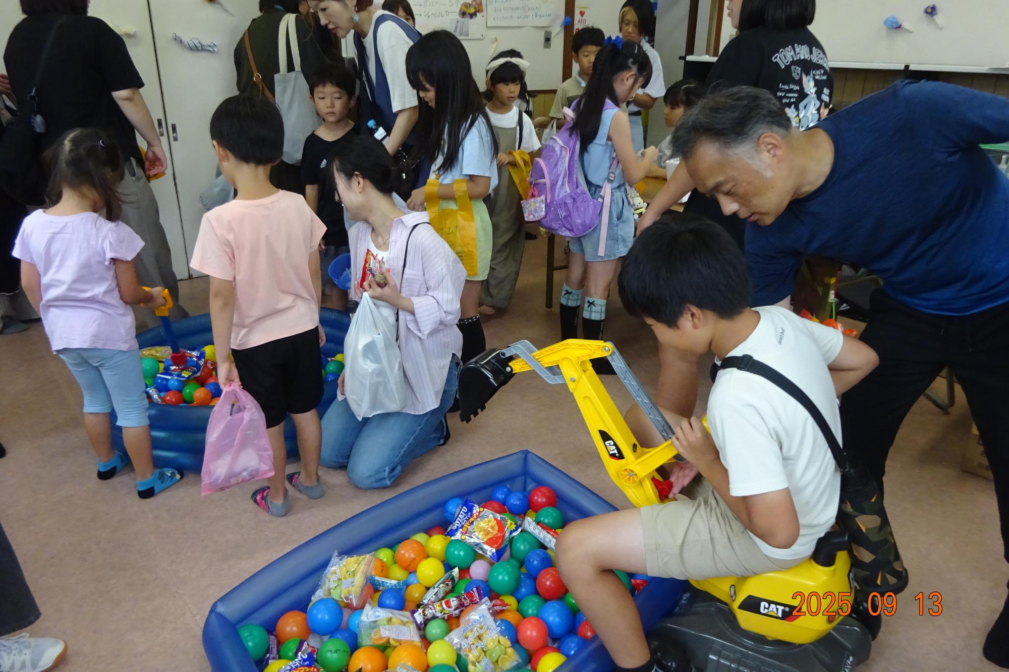 図書室で行われたおかしすくいに挑戦する参加者の写真