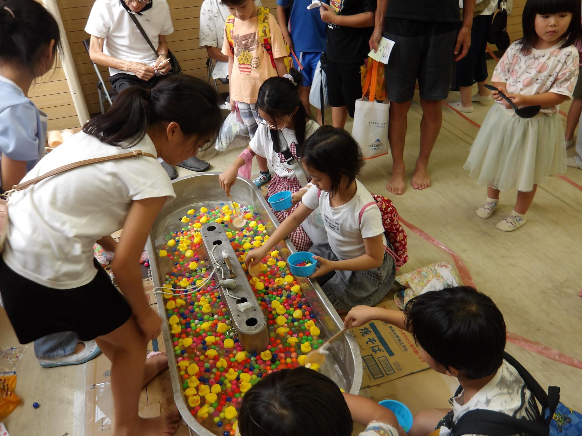 集会室で行われたスーパーボールで遊ぶ小学生児童の写真