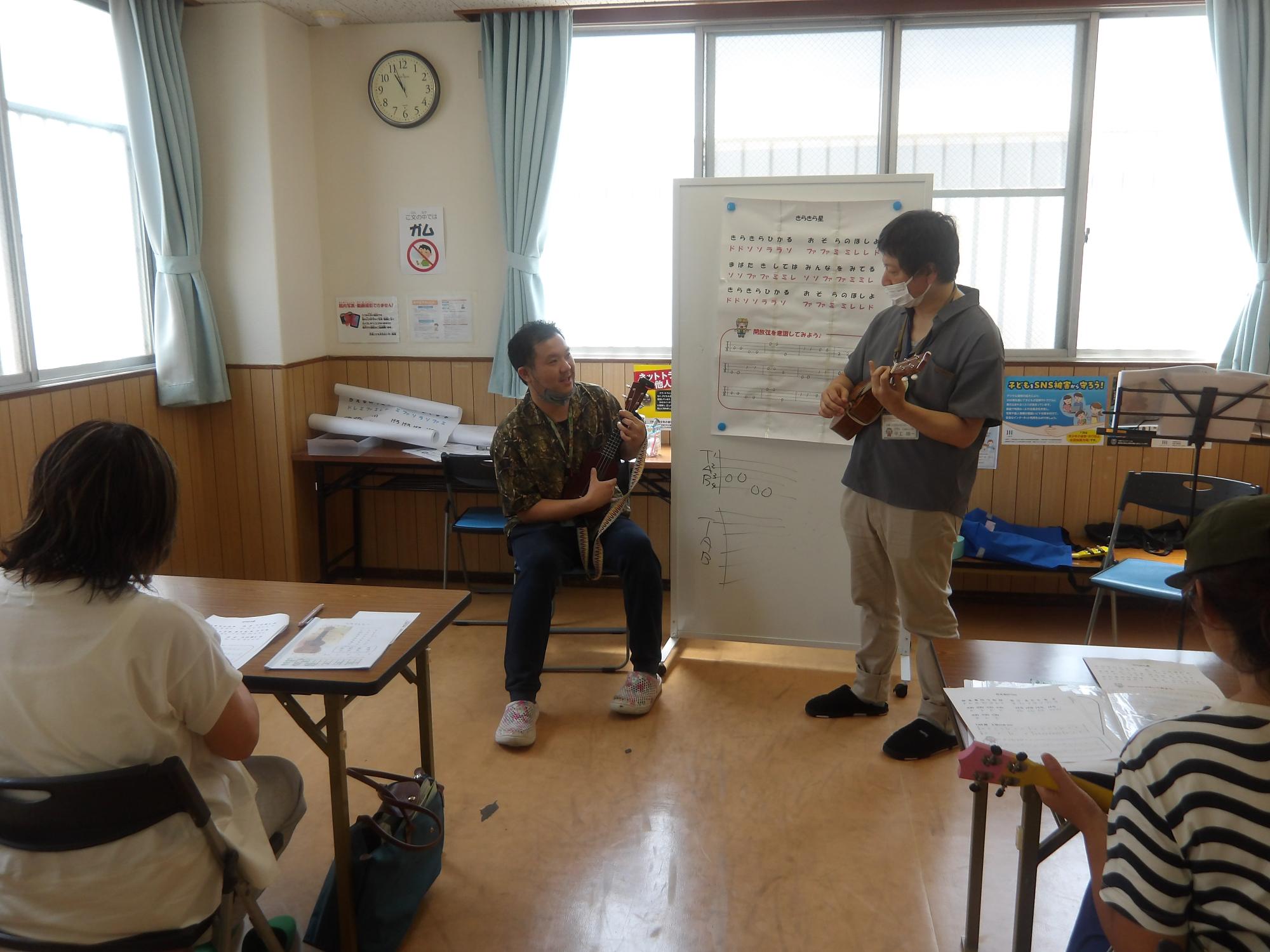 ウクレレを教えている姿の写真