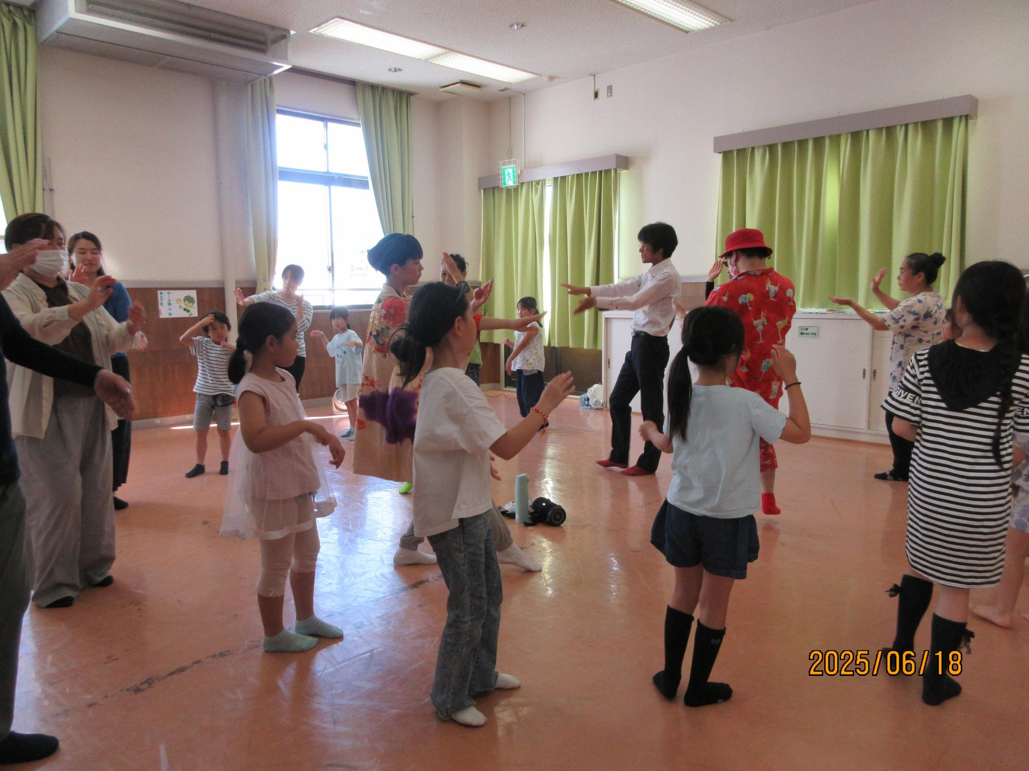 集会室で盆踊りを踊っているところの写真