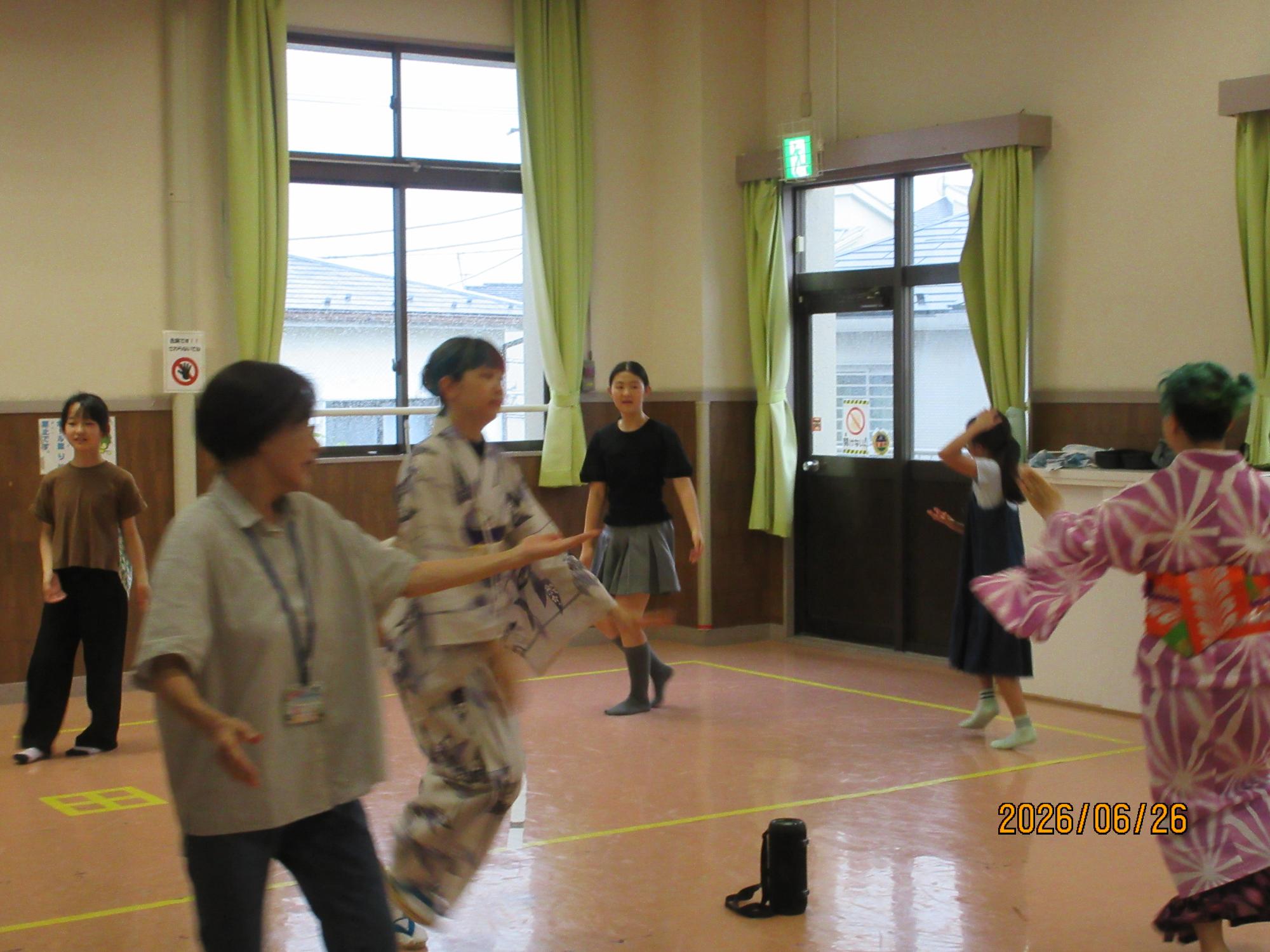 集会室で盆踊りを踊っているところの写真