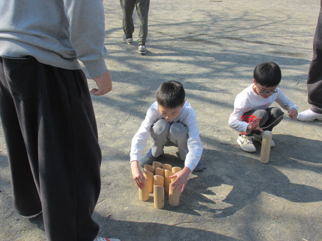 子どもがスキットルを並べている写真