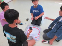 1人の男の子の話を3人の子どもが聞いている様子の写真