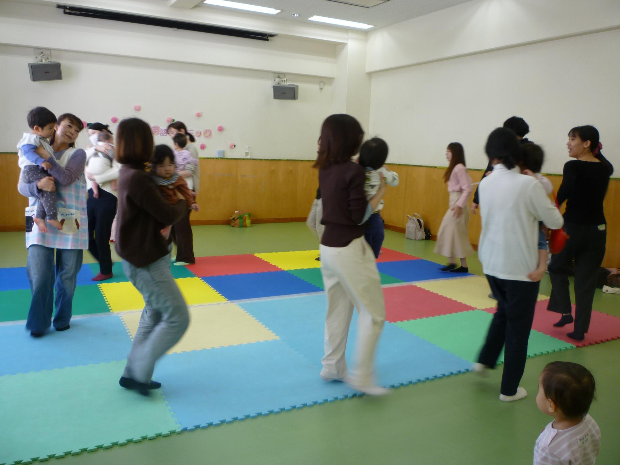 親子で英語の歌にあわせてリトミックをしている様子