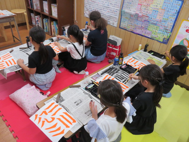 書道をする子どもたちの写真