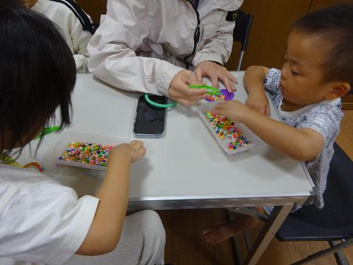 アイロンビーズを作る幼児親子の写真