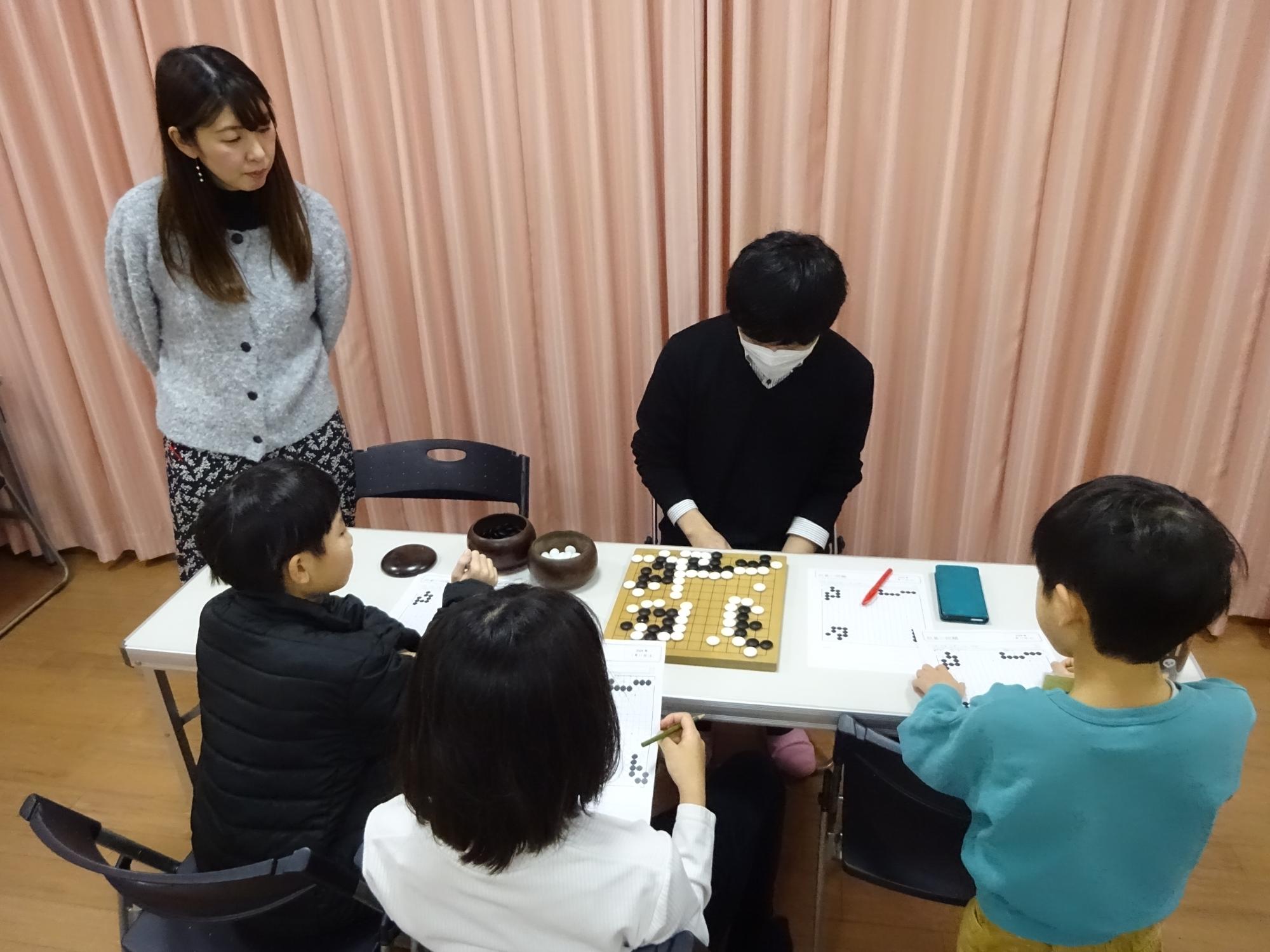 囲碁で先生の説明を聞いている様子