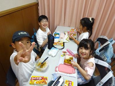 カレーを食べながら笑顔の子どもたちの写真