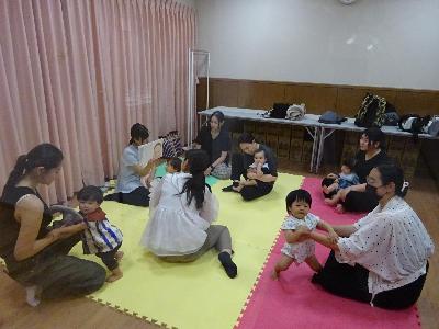 絵本の読み聞かせを聞いている幼児親子たちの写真