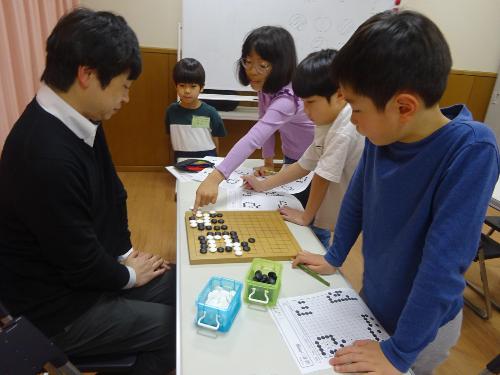 囲碁の問題を考えている子どもたちの写真