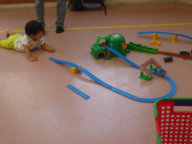 電車が走っている姿を下から眺めている幼児の写真