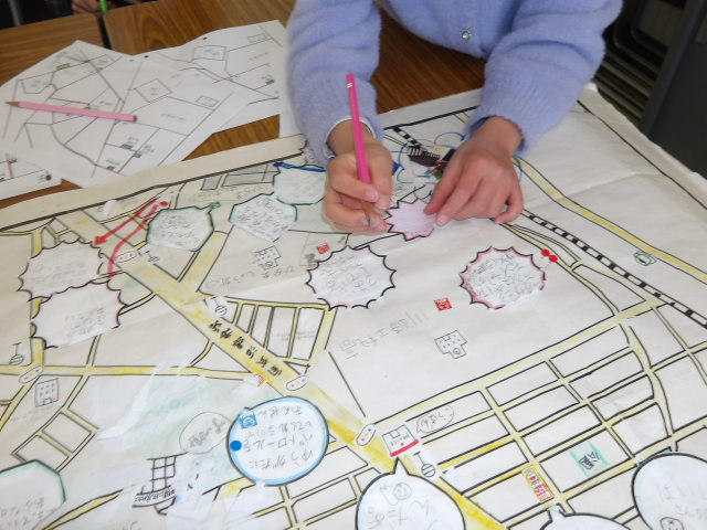 ハロウィンDEまち探検でメモをした内容を基に、安全マップを作る小学生の写真
