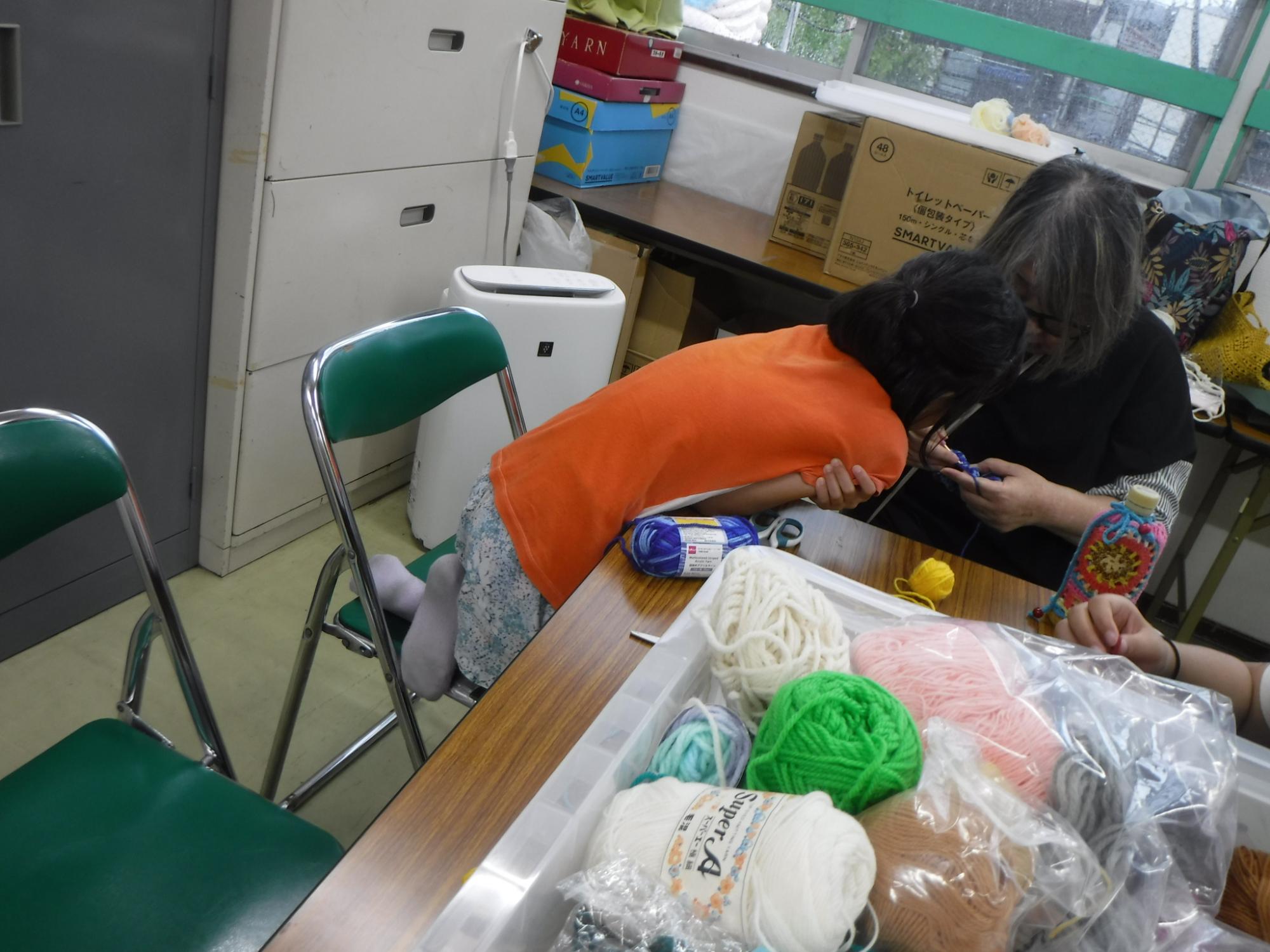 編み方を覗き込んでみている子どもの様子