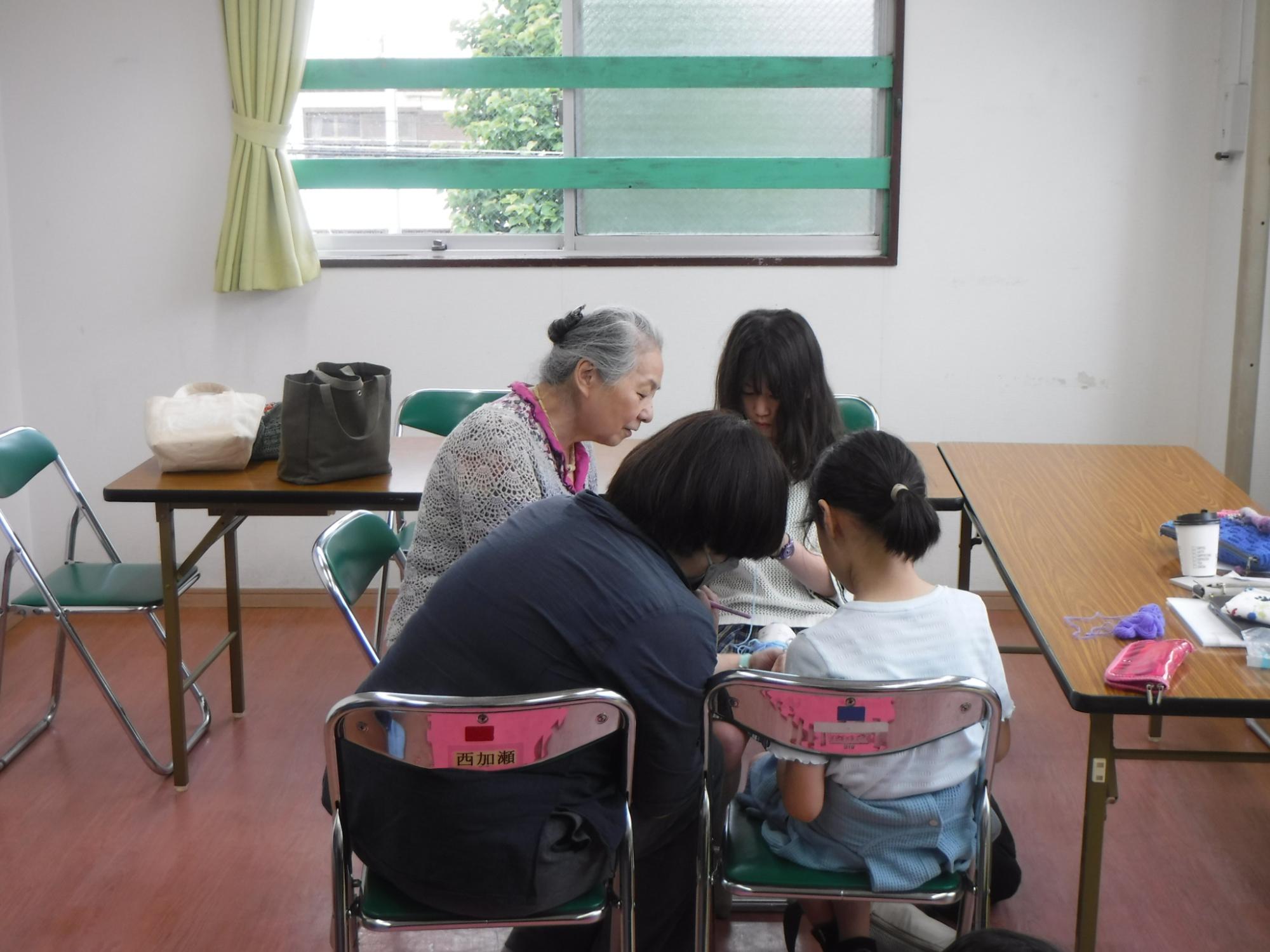 丁寧に編み方を教わっている様子