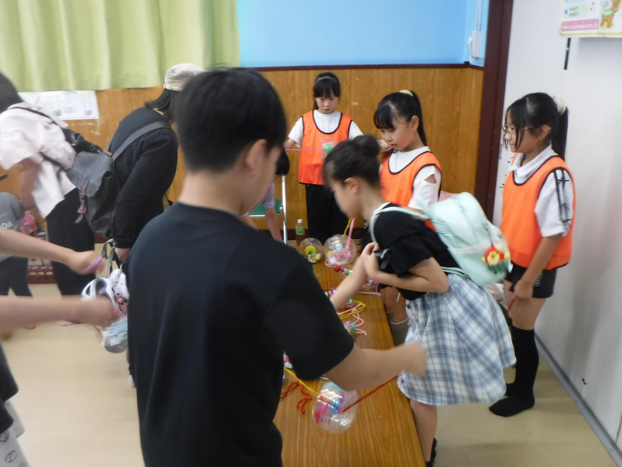 ぶんぶんごまコーナーで説明をしている子どもの写真