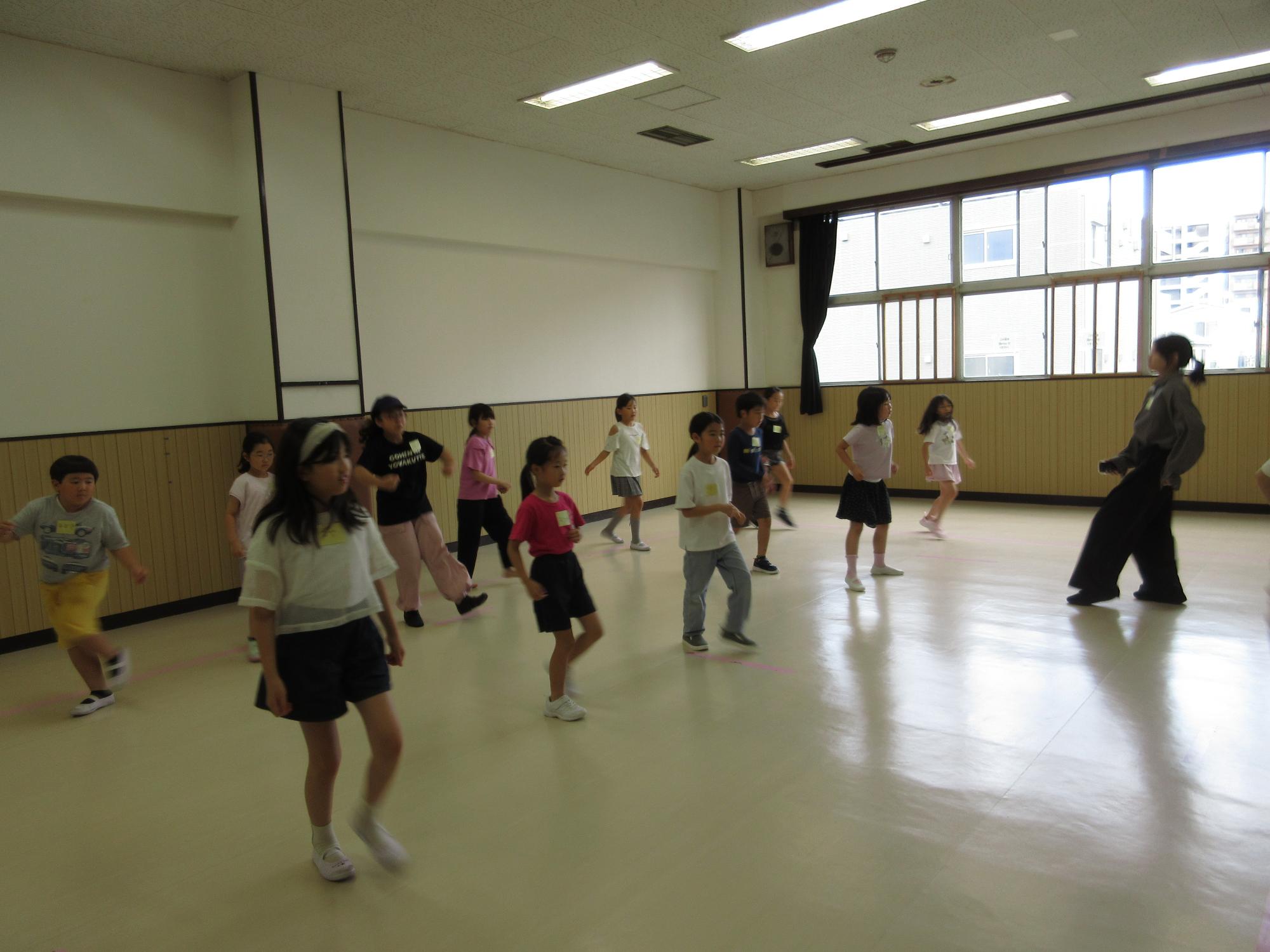 子どもたちが講師に続いてボックスをしている写真