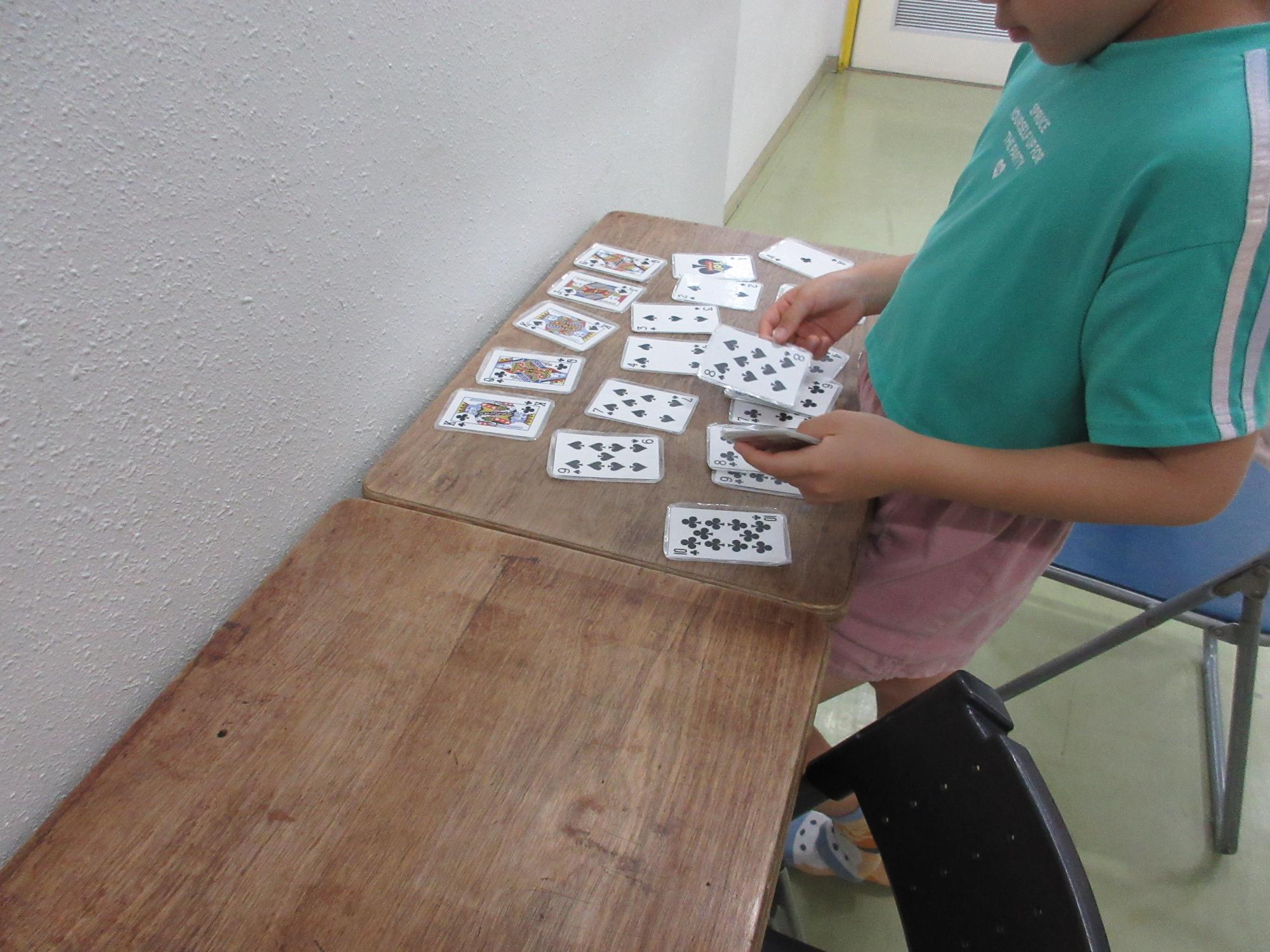 こんちゃれに挑戦中。ないのはどれだ？トランプを並べて考える子ども