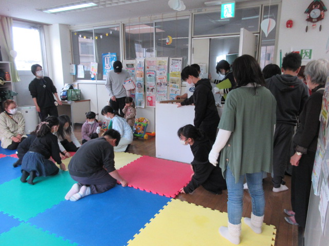 幼児室のマットを拭いて、元に戻す様子
