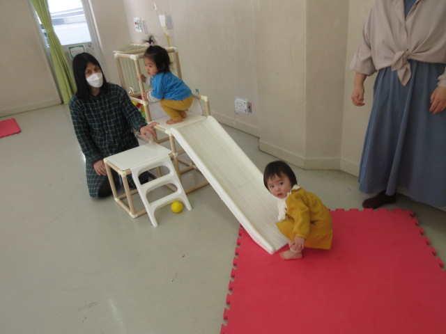 お友だちと一緒にすべり台をする様子の写真