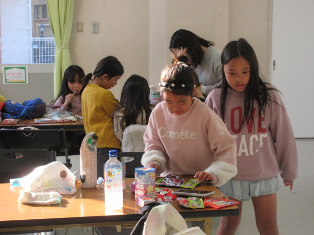 どのお菓子から食べようか迷っている子どもたちの様子の写真