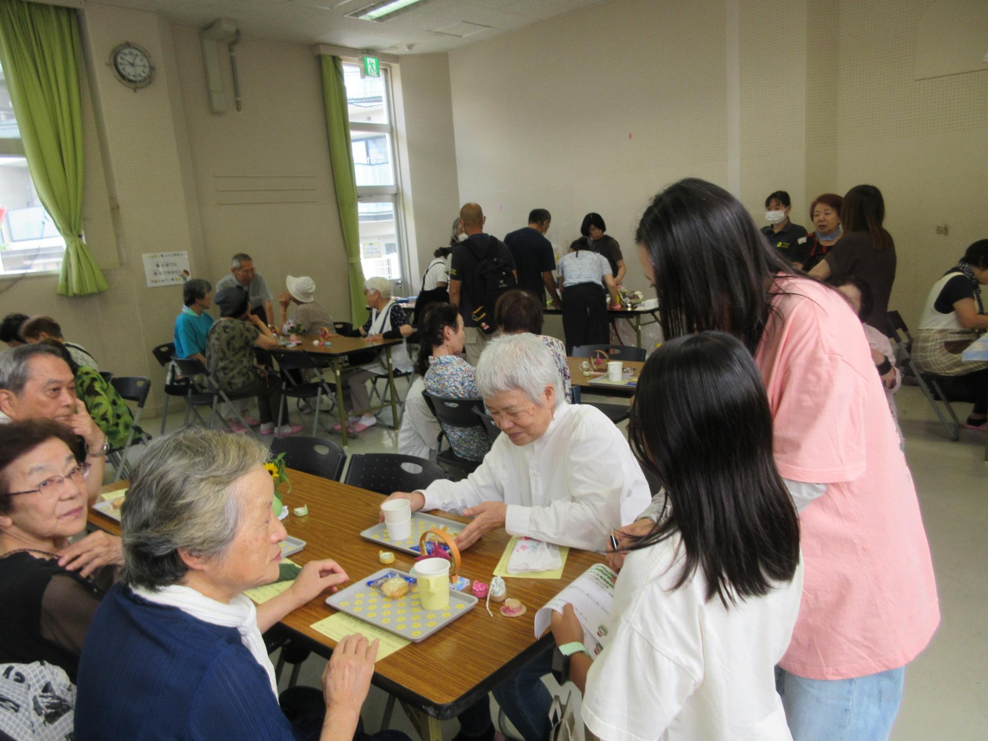 かき氷のオーダーを取るお手伝いをする小学生の様子の写真