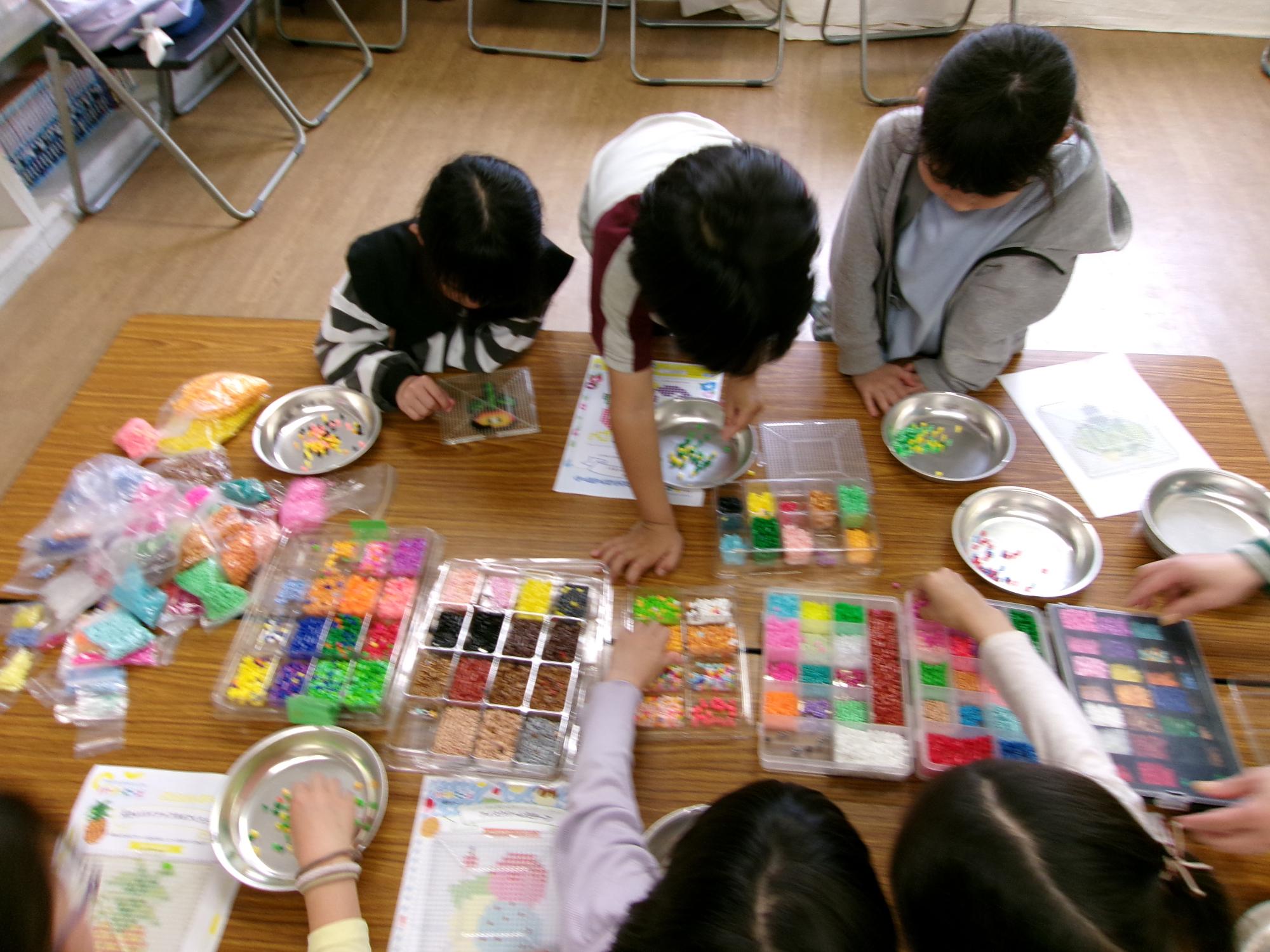 作りたい植物の下絵と足論ビーズを選んでいる写真