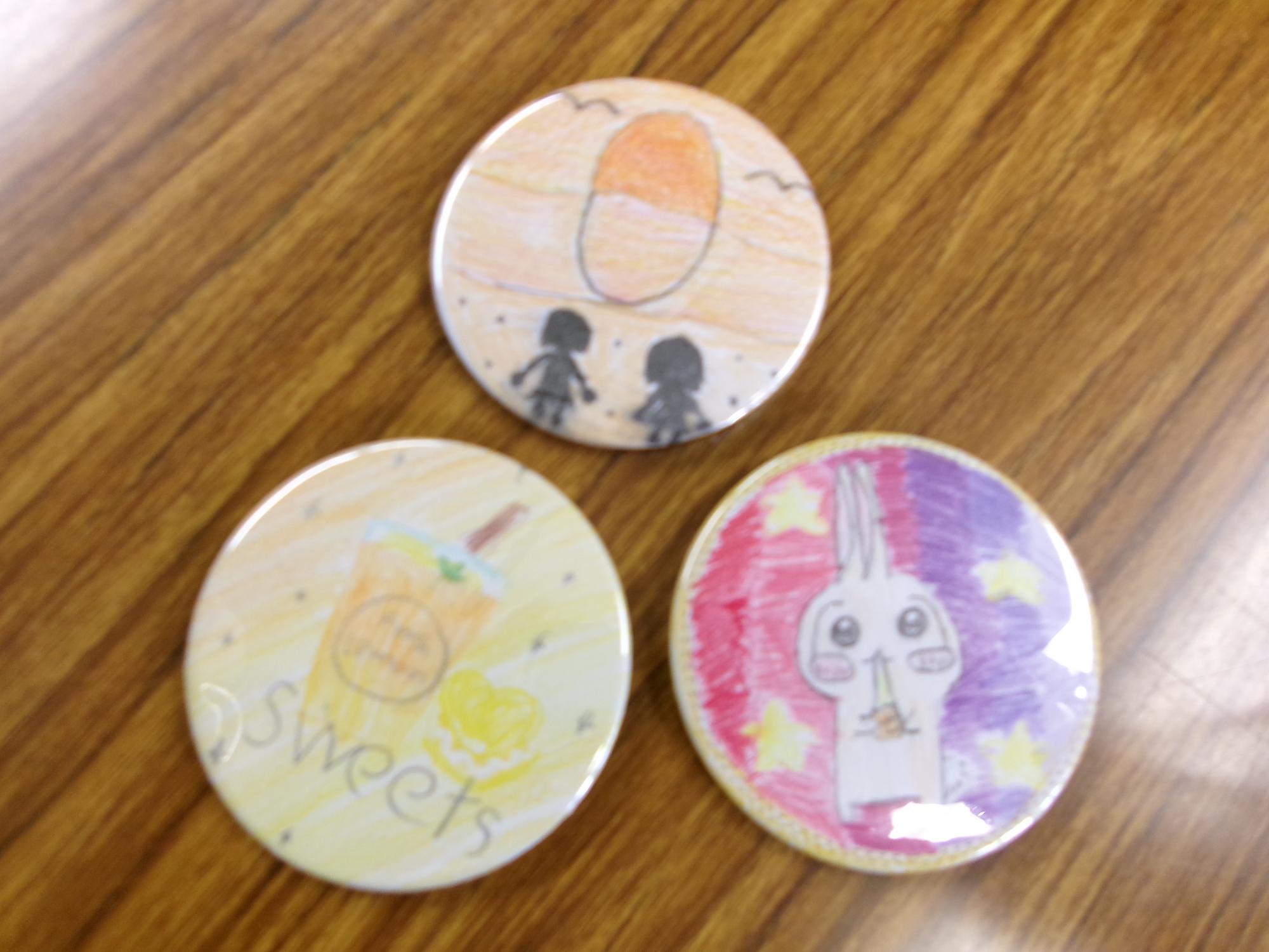 子どもが描いた絵で出来た缶バッジの写真