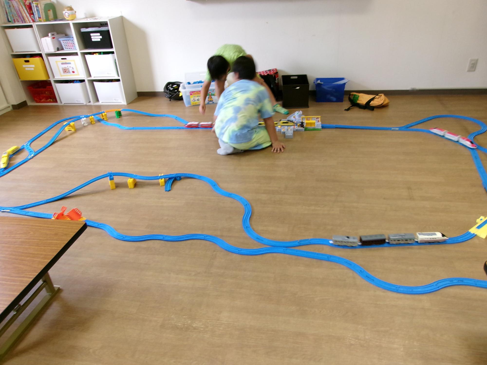 床一面にレールを繋げて大きなサークルを作っている写真