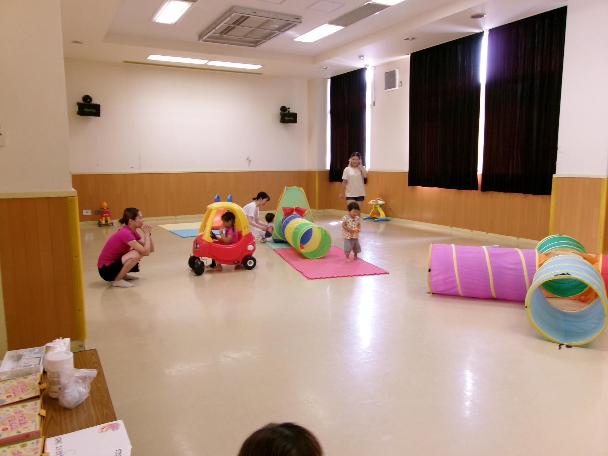 大型遊具で遊んでいる幼児親子の写真