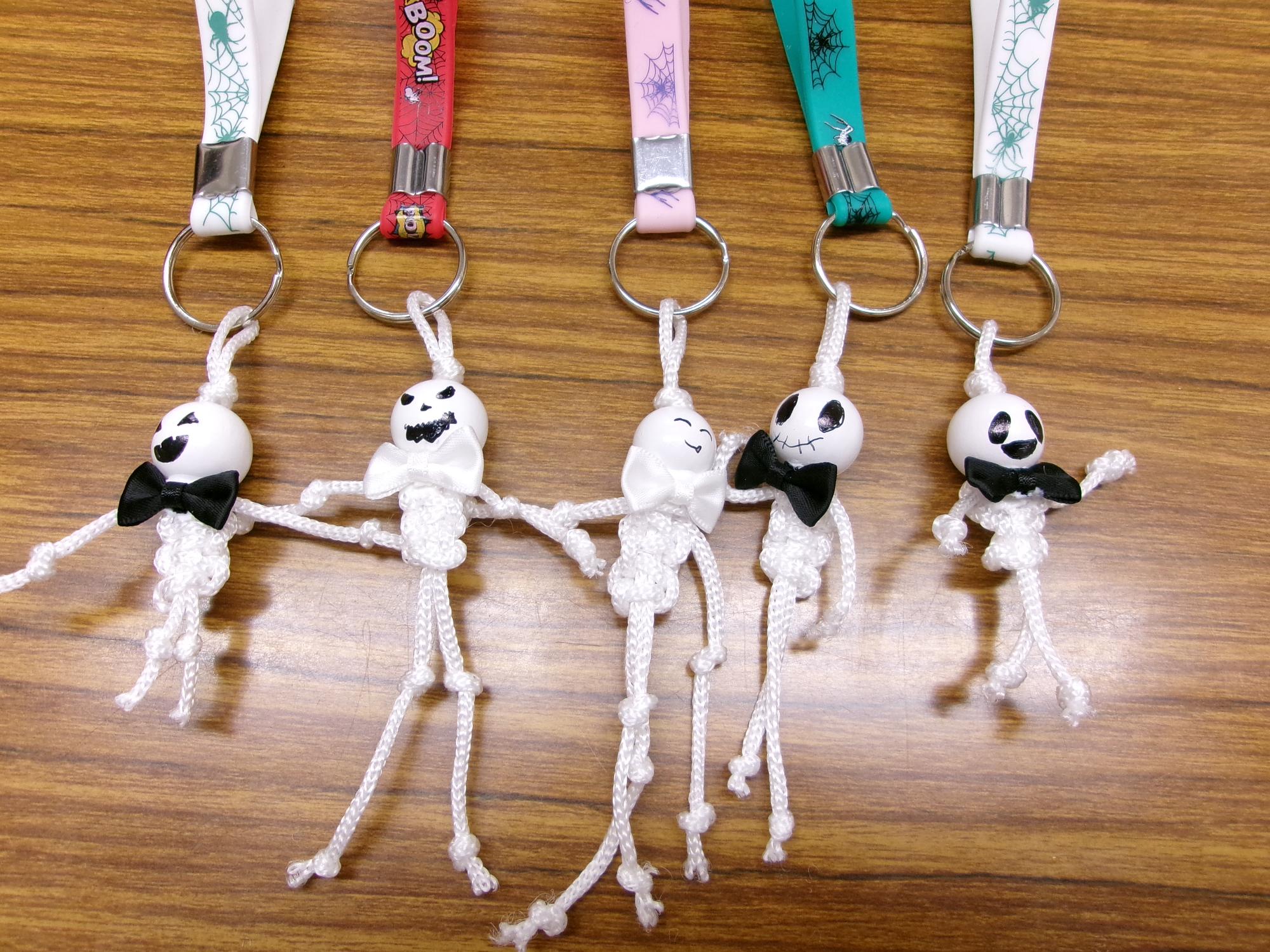 ウッドビーズを顔、からだを紐で編みをキーホルダーにしたハロウィンがいこつの写真