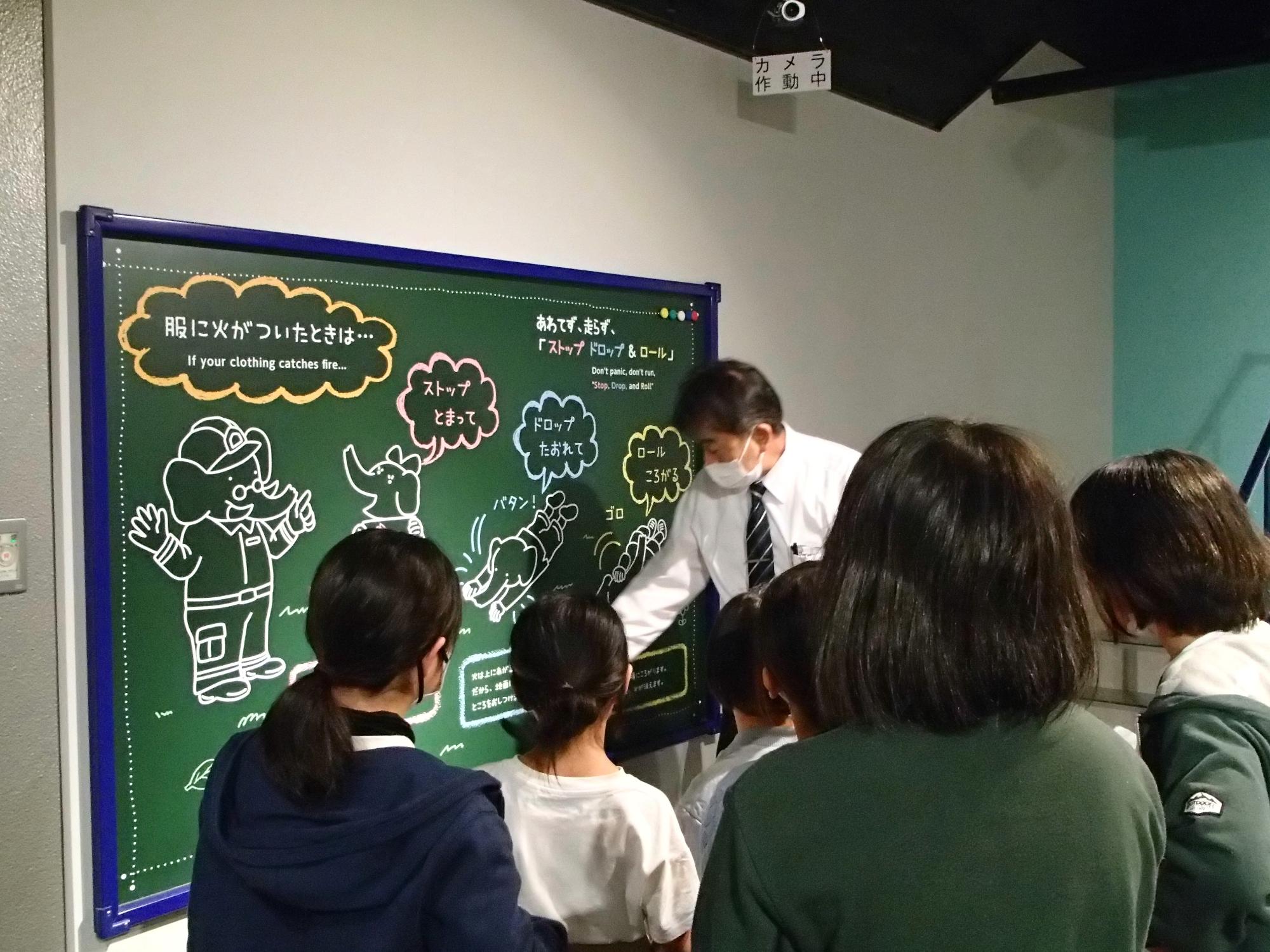 子どもたちが施設の方から説明を受けている写真