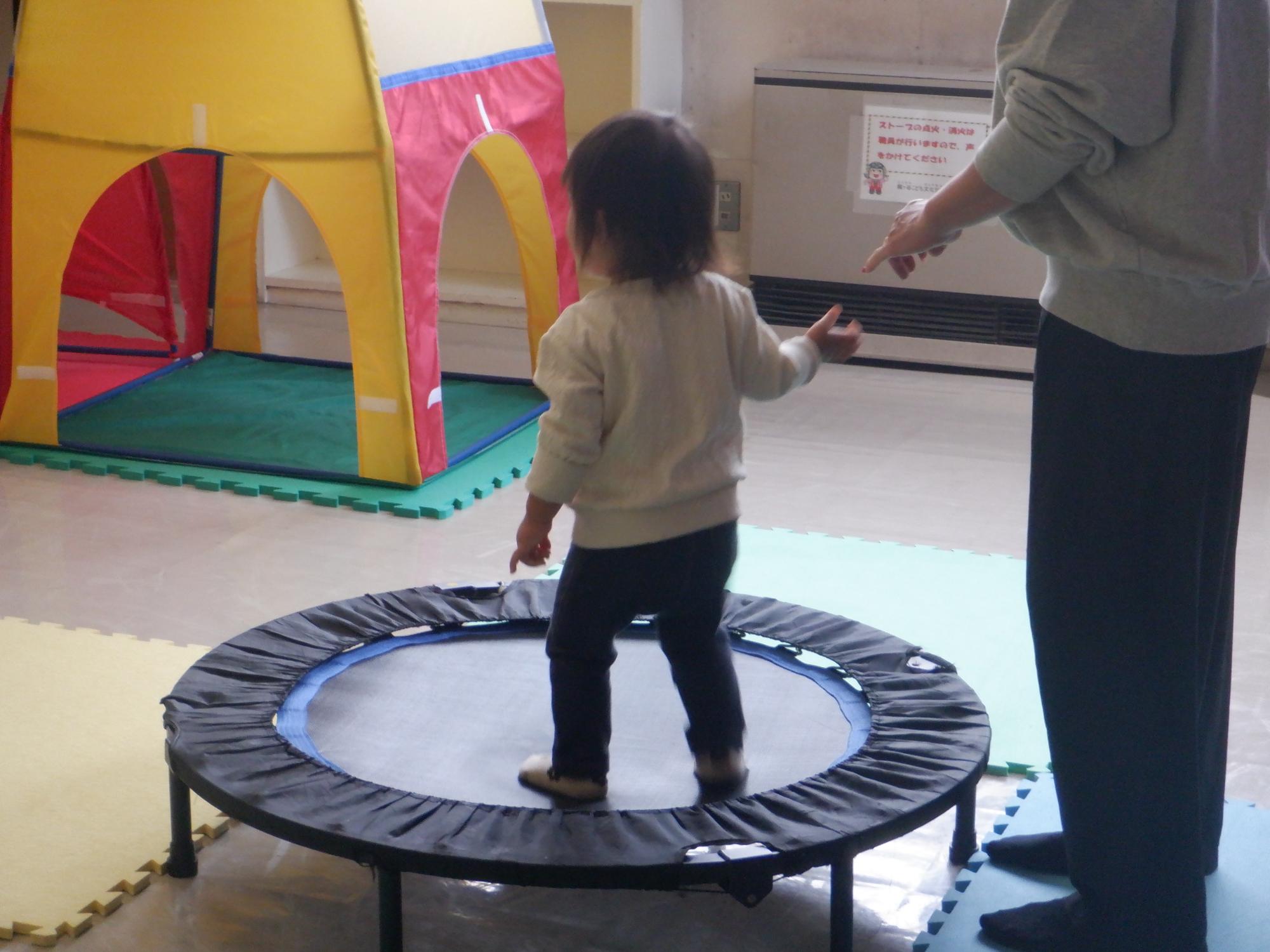 トランポリンで遊ぶ幼児の姿