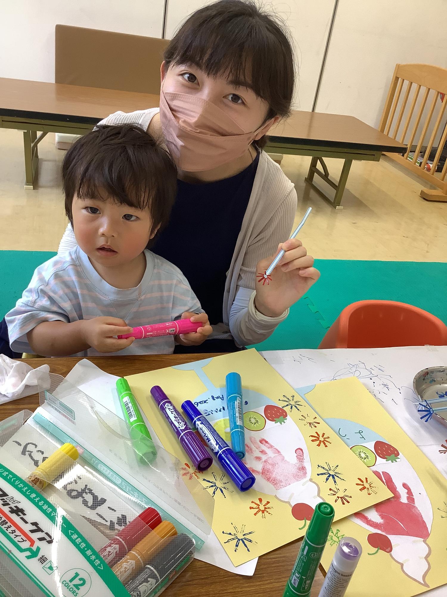 作品と一緒に撮影している親子の写真