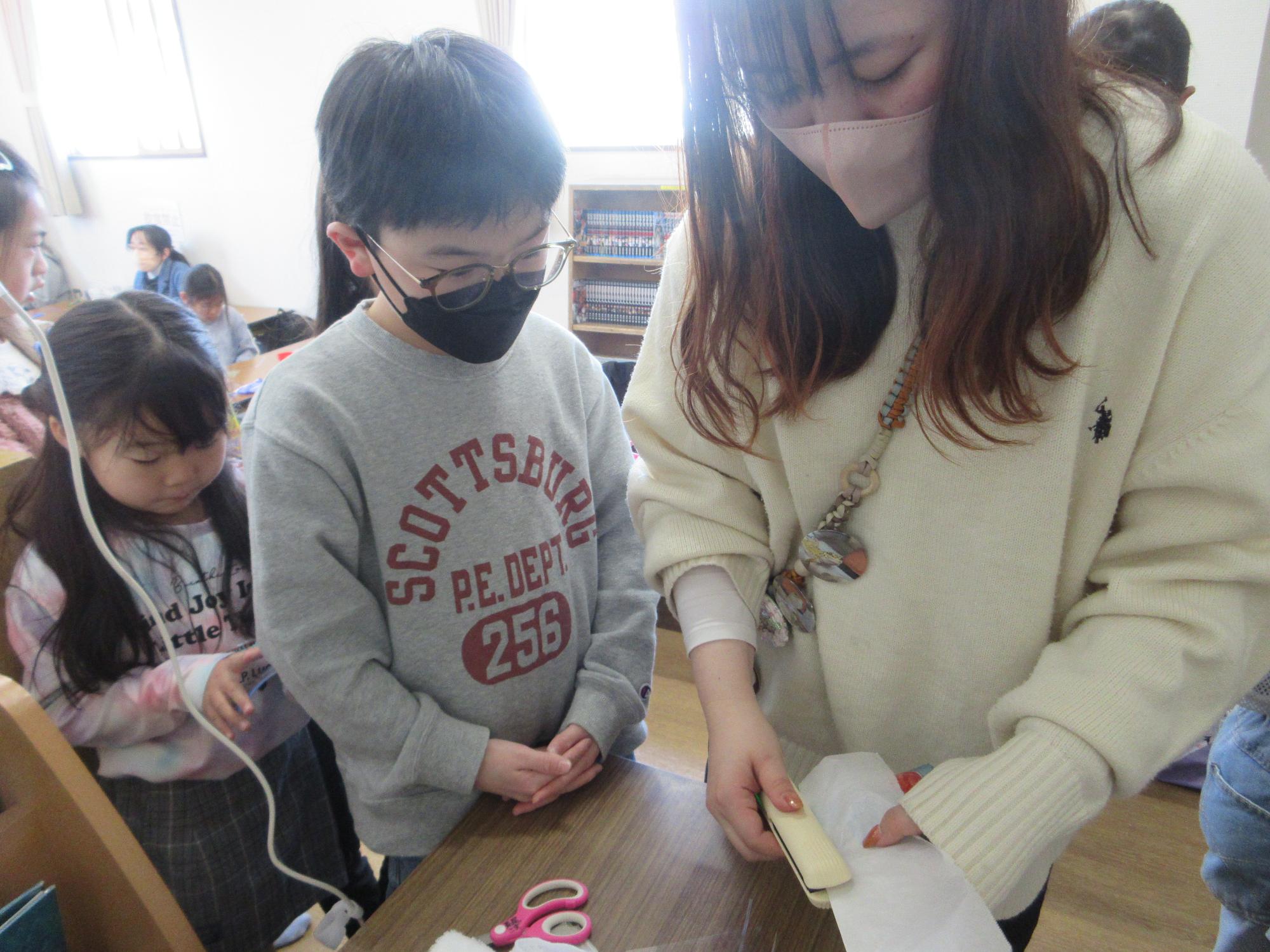 ヘアアイロンで作品を完成させる様子