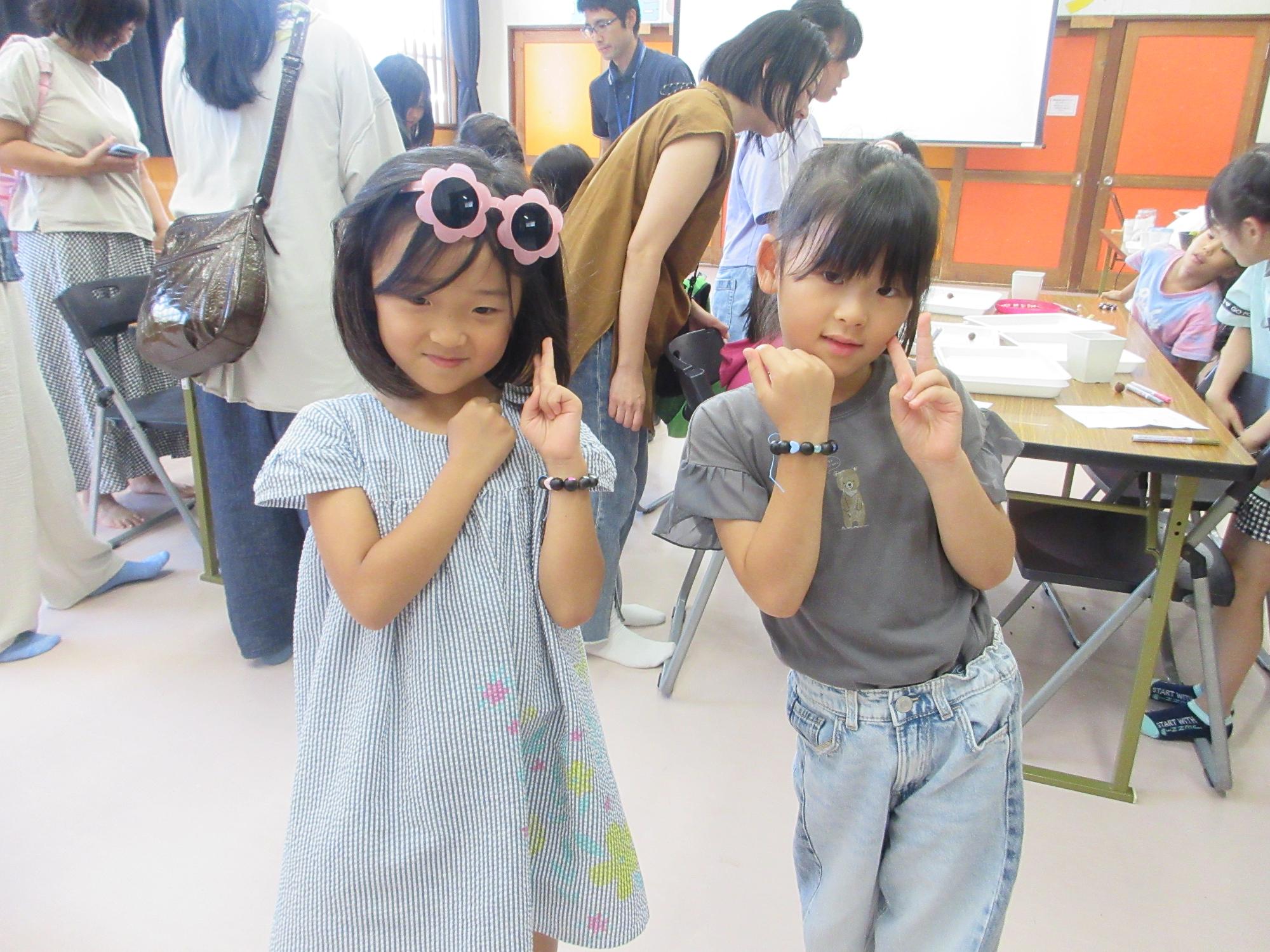 ブレスレットをつけるこどもたちの写真
