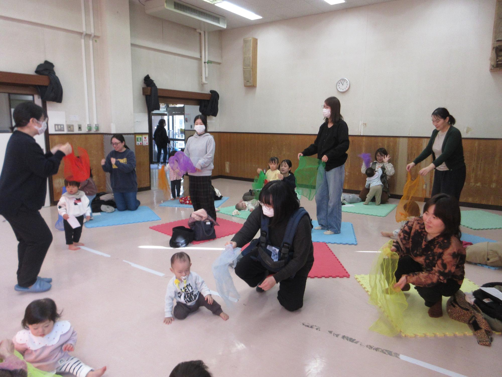 スカーフで遊ぶこどもたちの写真