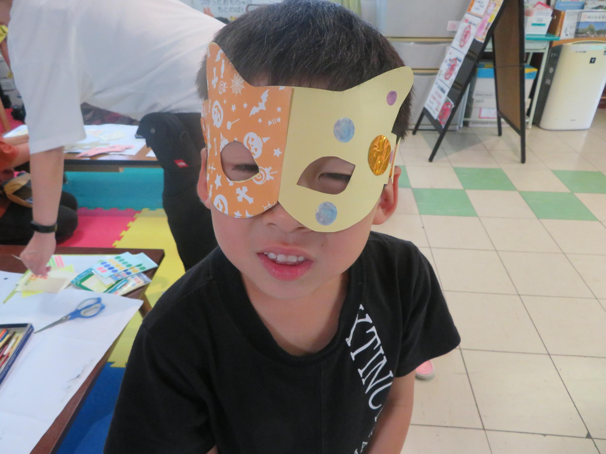 完成作品をつけたこどもの写真