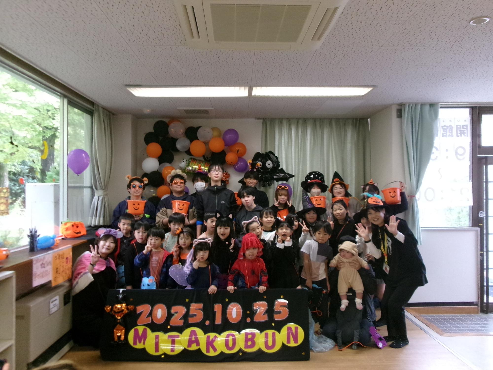 特設のフォトスポット前で撮影した、ハロウィンパレードに参加した子どもたちとスタッフの集合写真