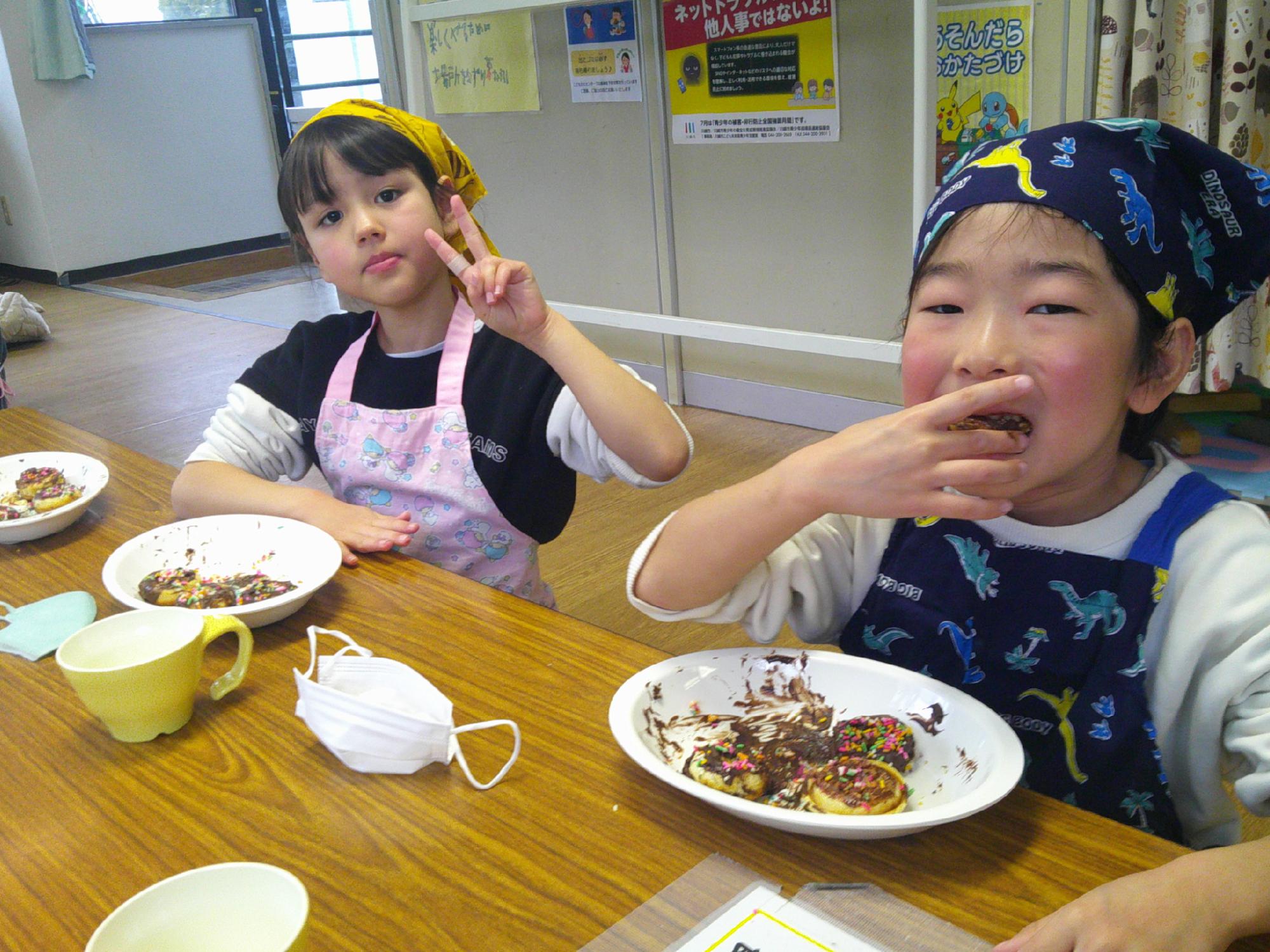 児童がドーナツを食べている様子の写真