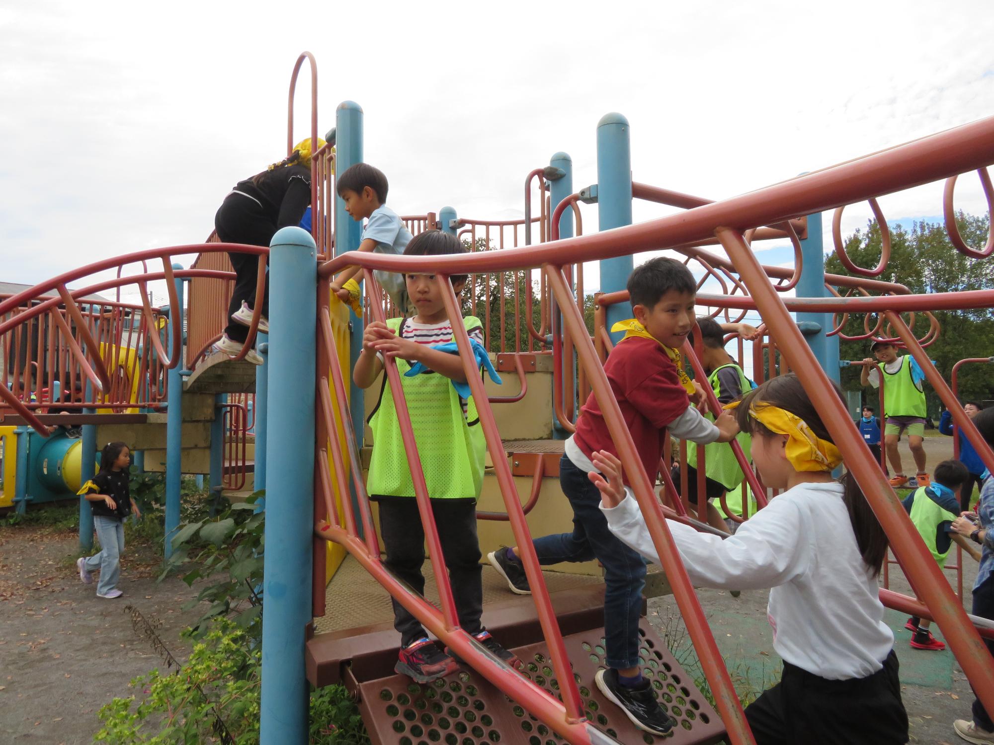 参加児童たちが公園の遊具で遊んでいる様子の写真
