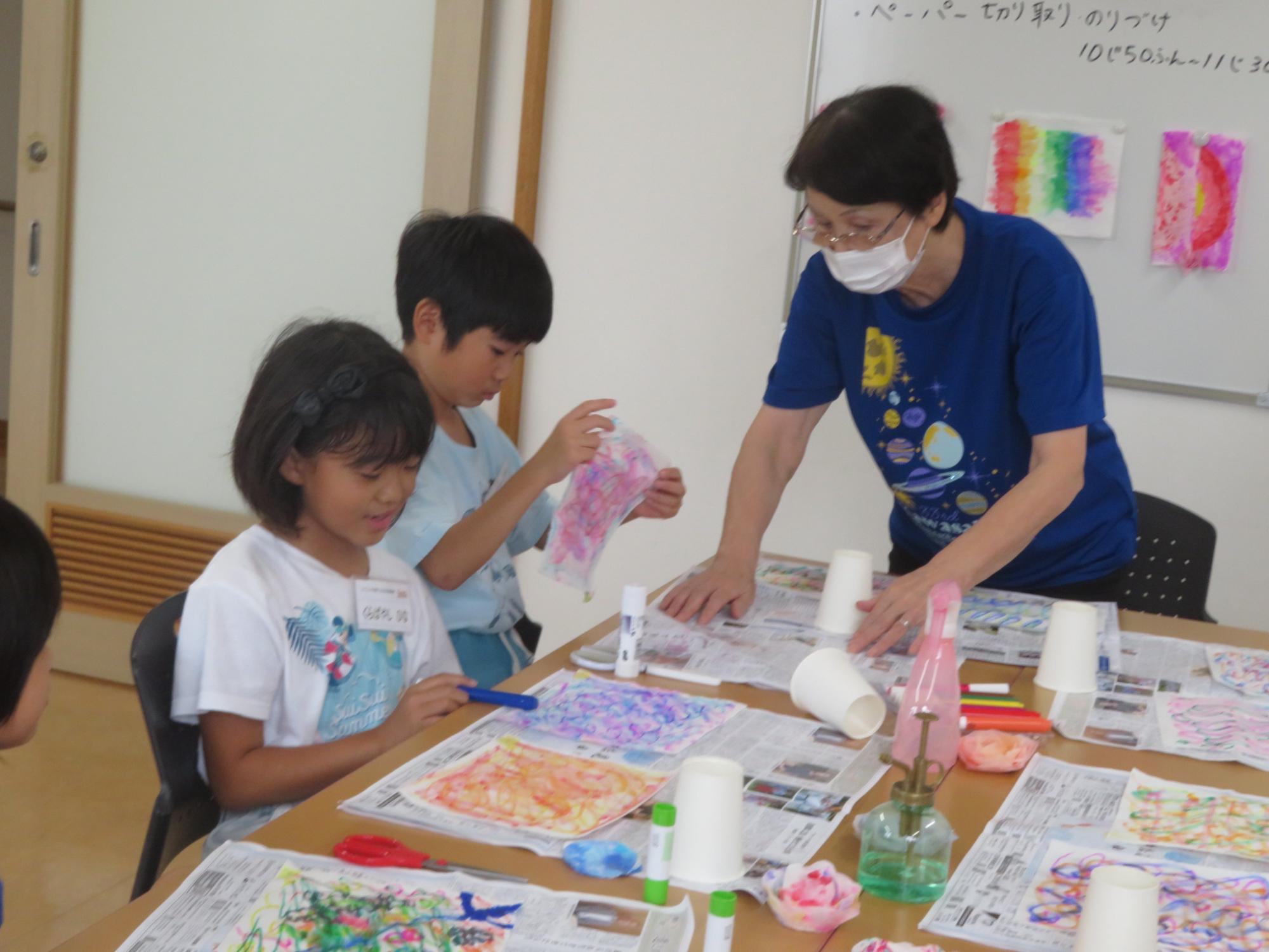 工作で使うキッチンペーパーに模様を描いている様子