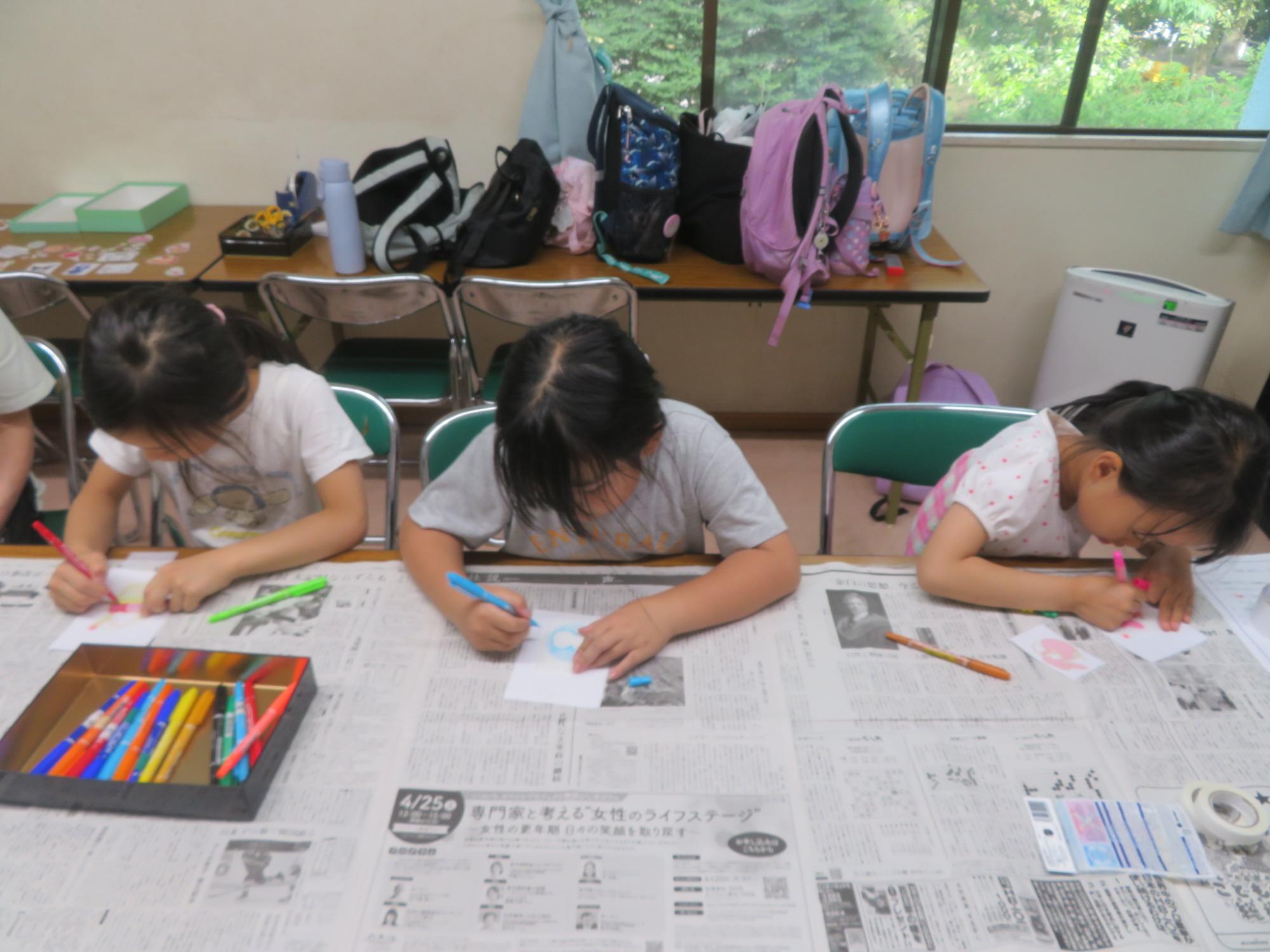 真剣にぷにぷにシール制作中の小学生